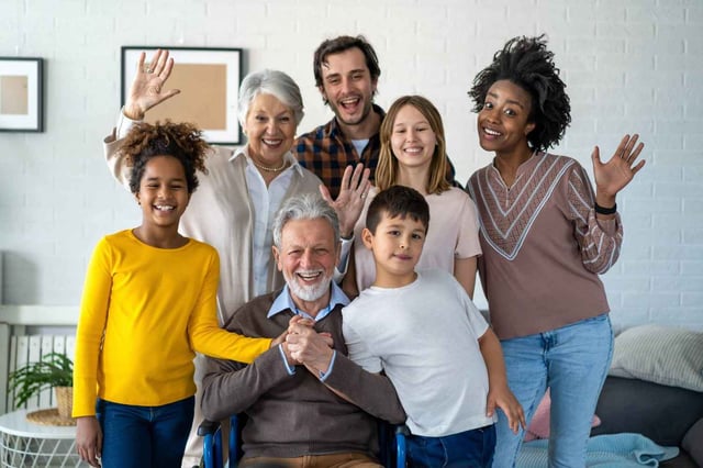Family Waving And Smiling Together