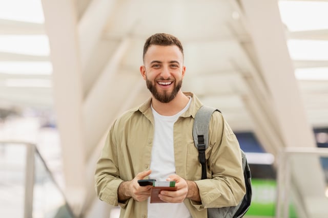 Smiling Man With Passport At Modern Airport