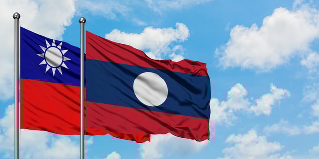 Taiwan And Laos Flag Waving In The Wind Against White Cloudy