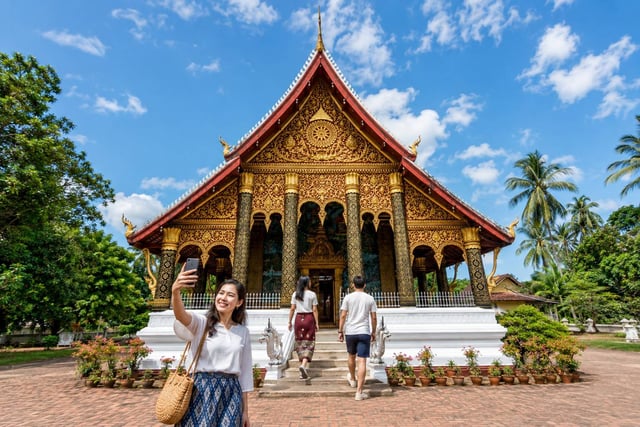 Tourists Entering Wat Ho Siang Temple Laos