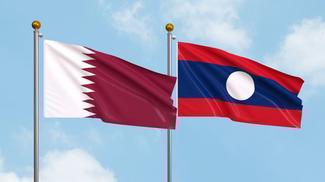 Waving Flags Of Qatar And Laos On Sky Background