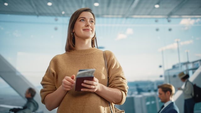 Women Holding Passport In Airport