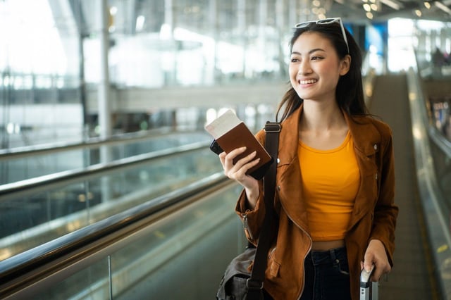 Young Happy Women Holding Passport In Airport