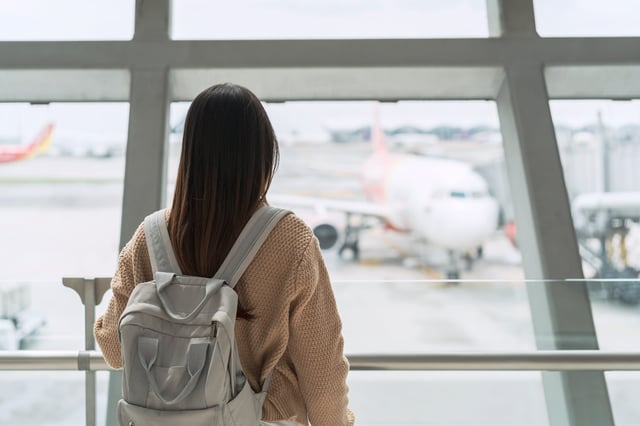 Young Women Stand In Airport