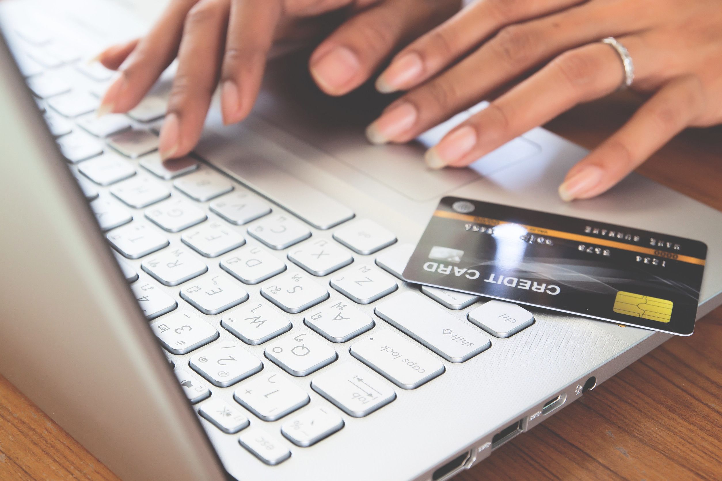 Hands typing with credit card