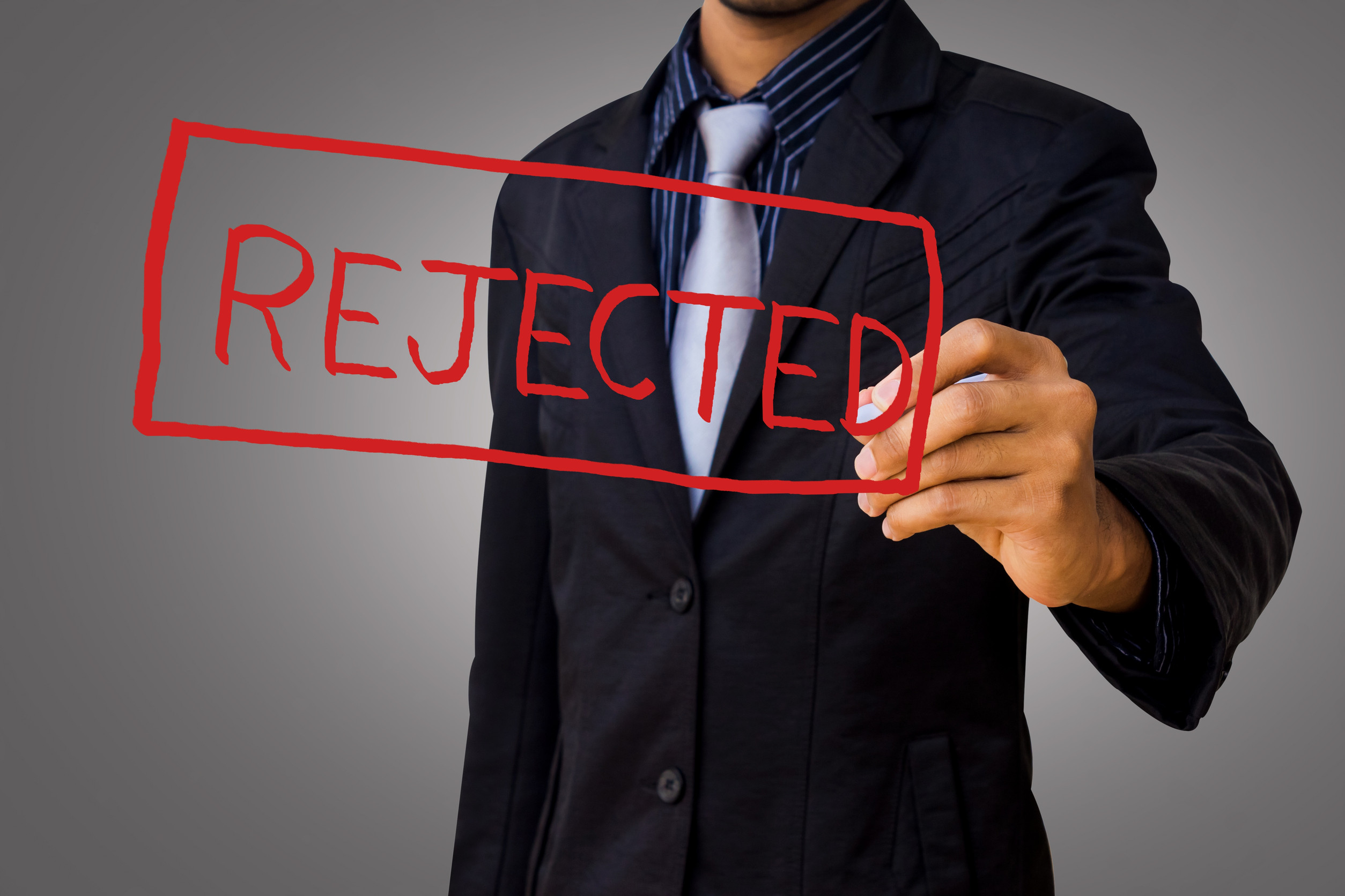 Businessman looking disappointed after visa application rejection