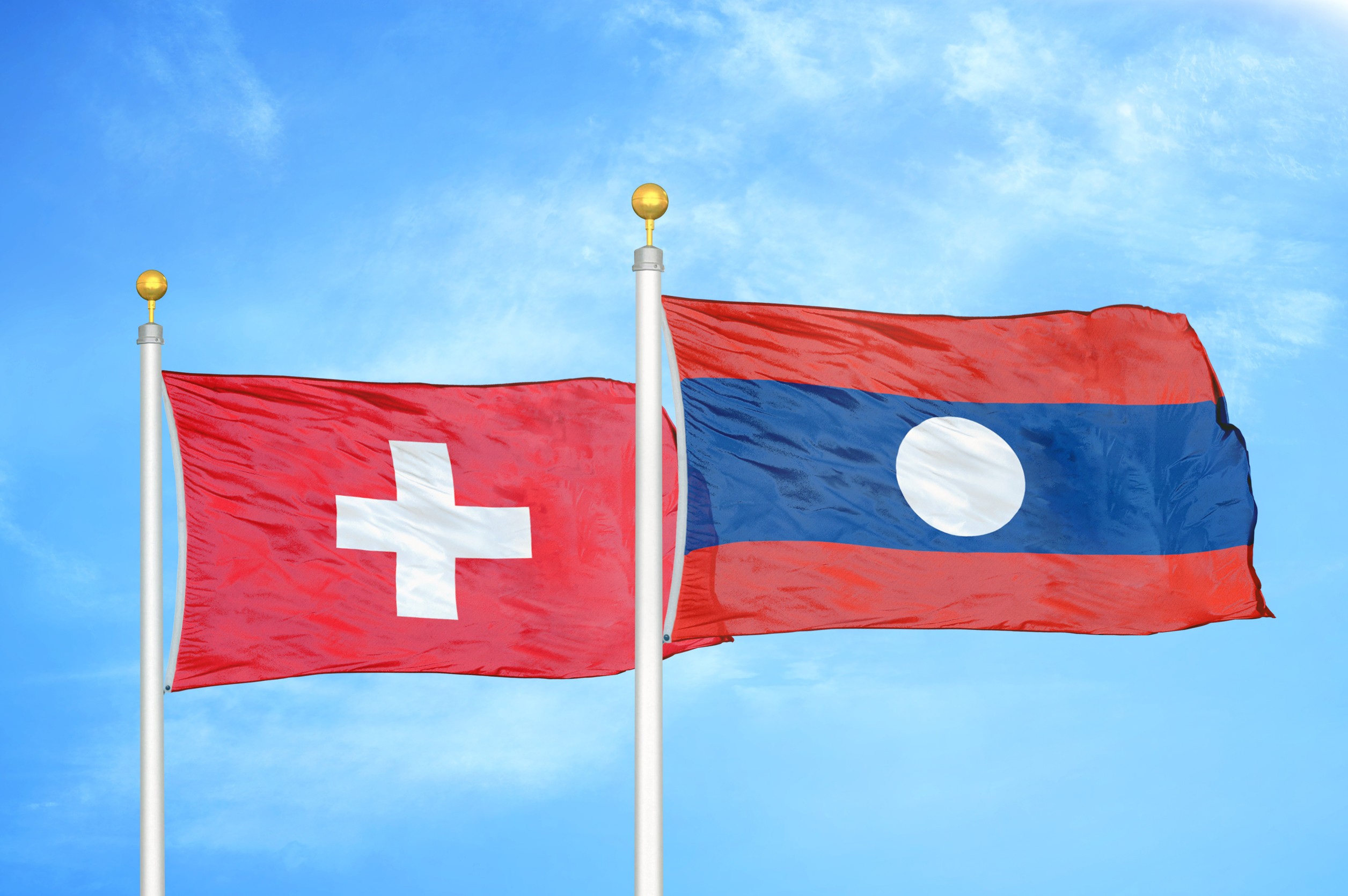 Swiss and Lao national flags waving